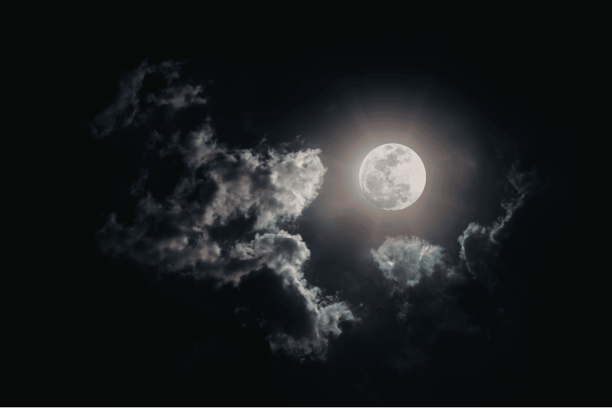 Lua cheia entre nuvens como referência para imaginar o céu visto de luas de Júpiter ou Saturno